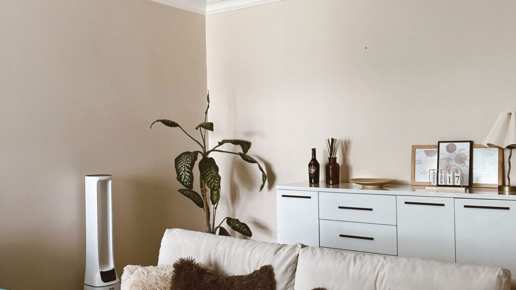 Warm cozy living room with neutral furniture, soft lighting, and simple decor.