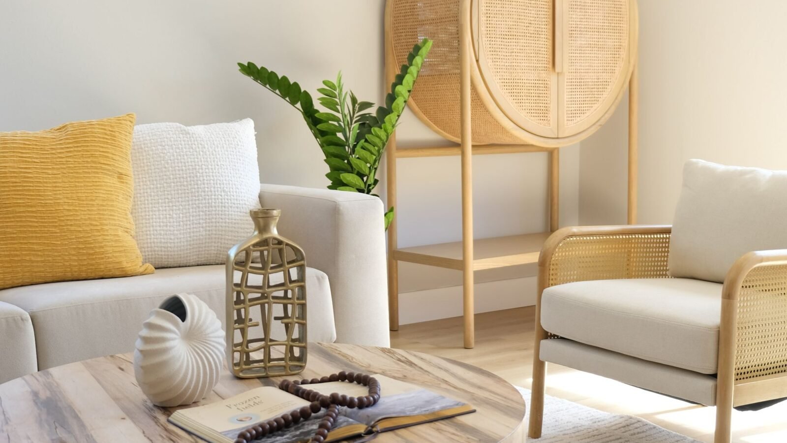 Bright living room with neutral furniture, wood, woven details, and natural decor.