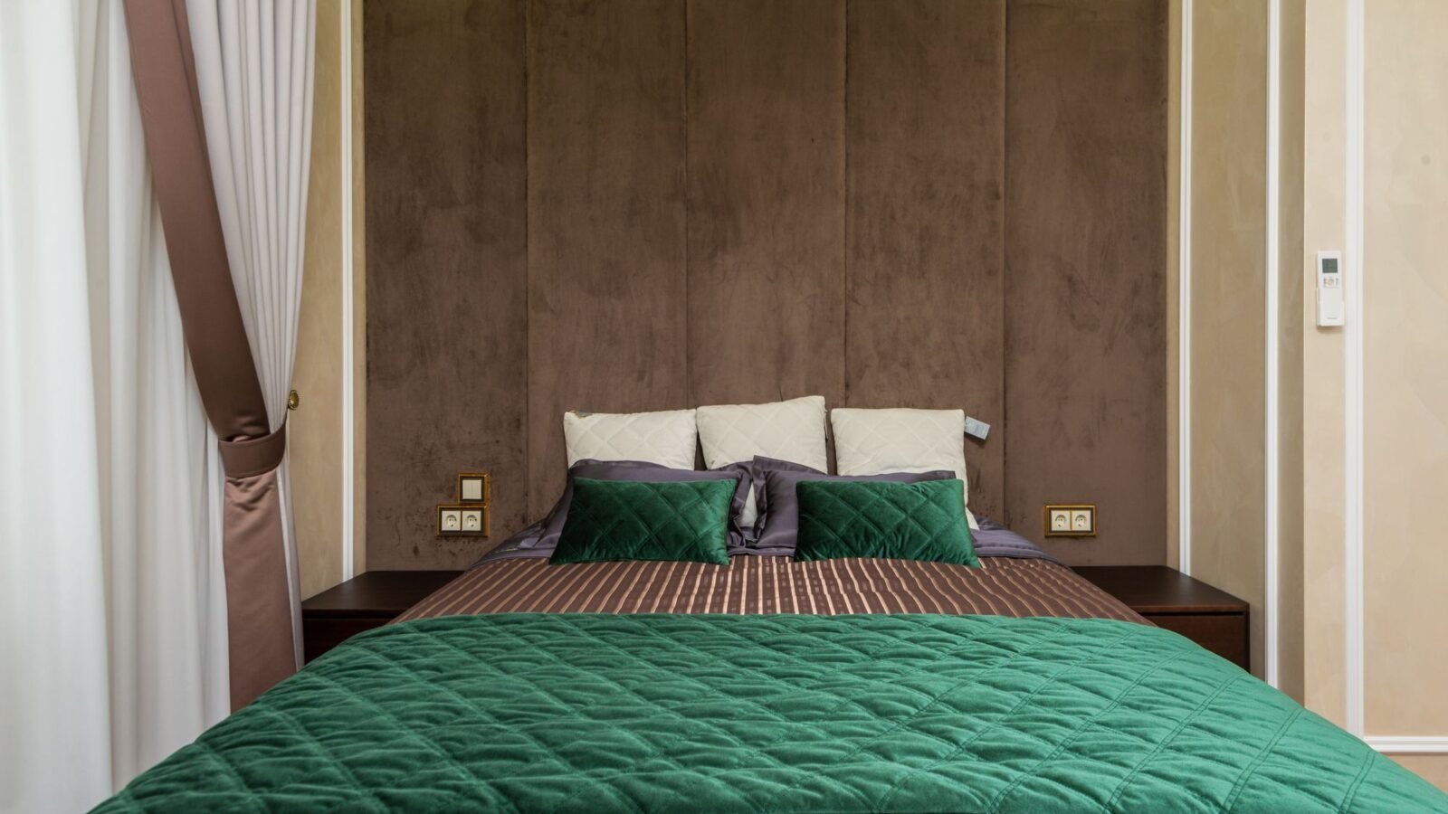 Modern bedroom with sage green bedding and soft neutral decor.