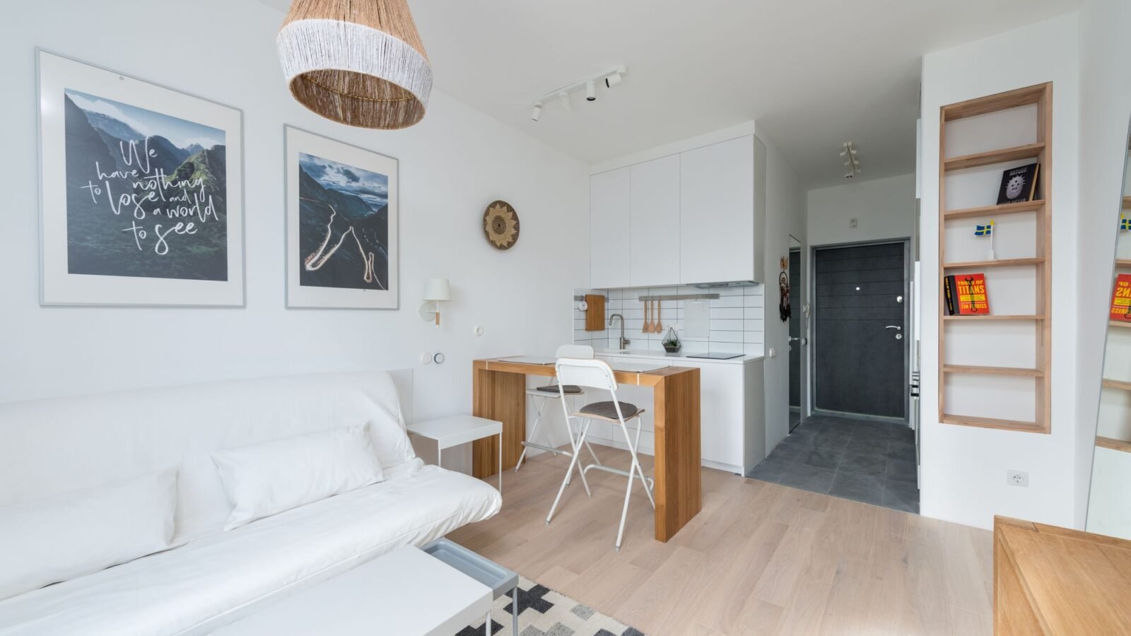 Bright compact living room with a small kitchen zone and space-saving furniture.