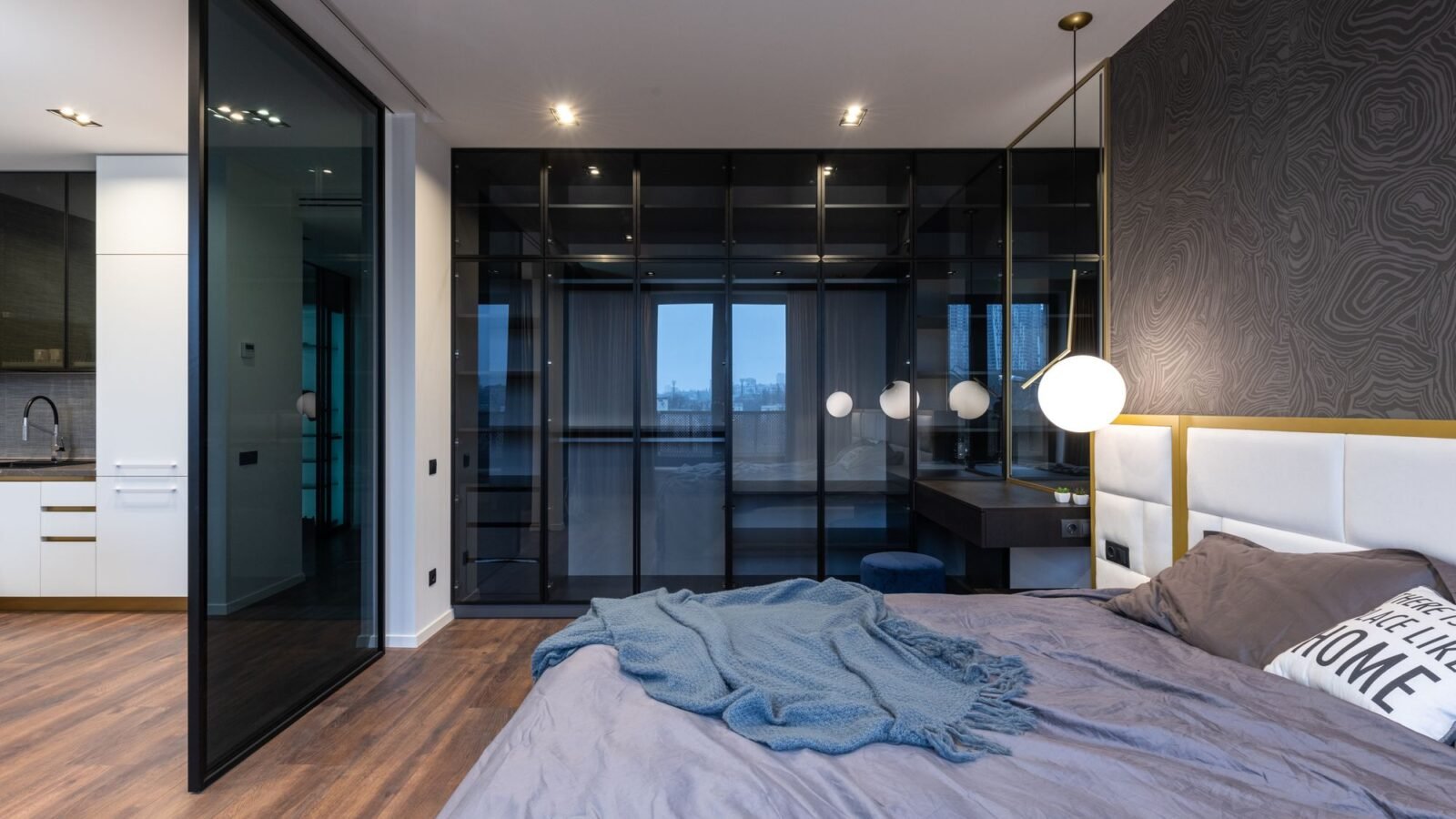 Modern studio apartment with sleeping area positioned beside the kitchen.