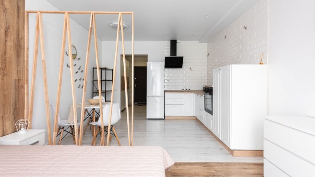 Modern studio apartment with an open kitchen, compact living area, and efficient layout.