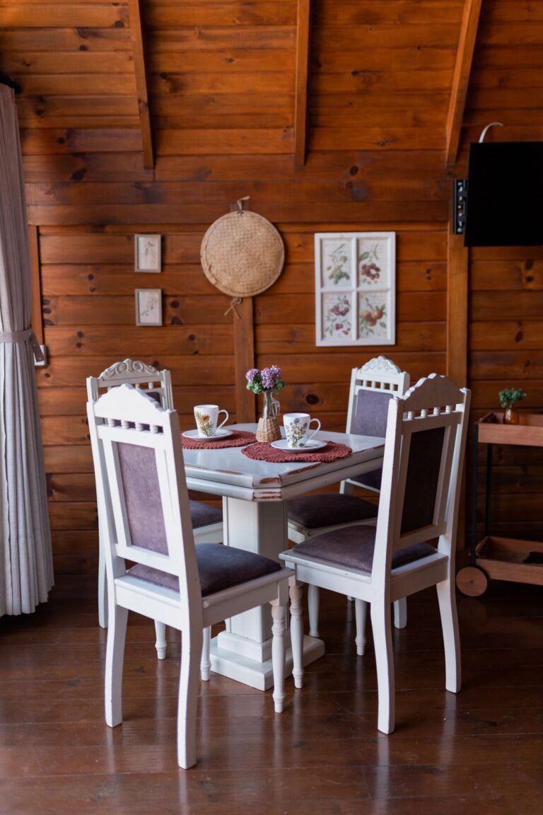 Cozy rustic dining room with a wooden table and white chairs