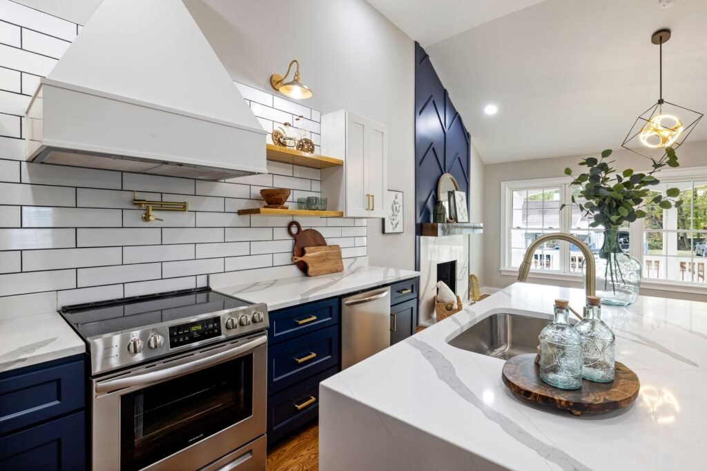 Farmhouse-style kitchen with blue cabinetry, subway tile, and open wood shelving