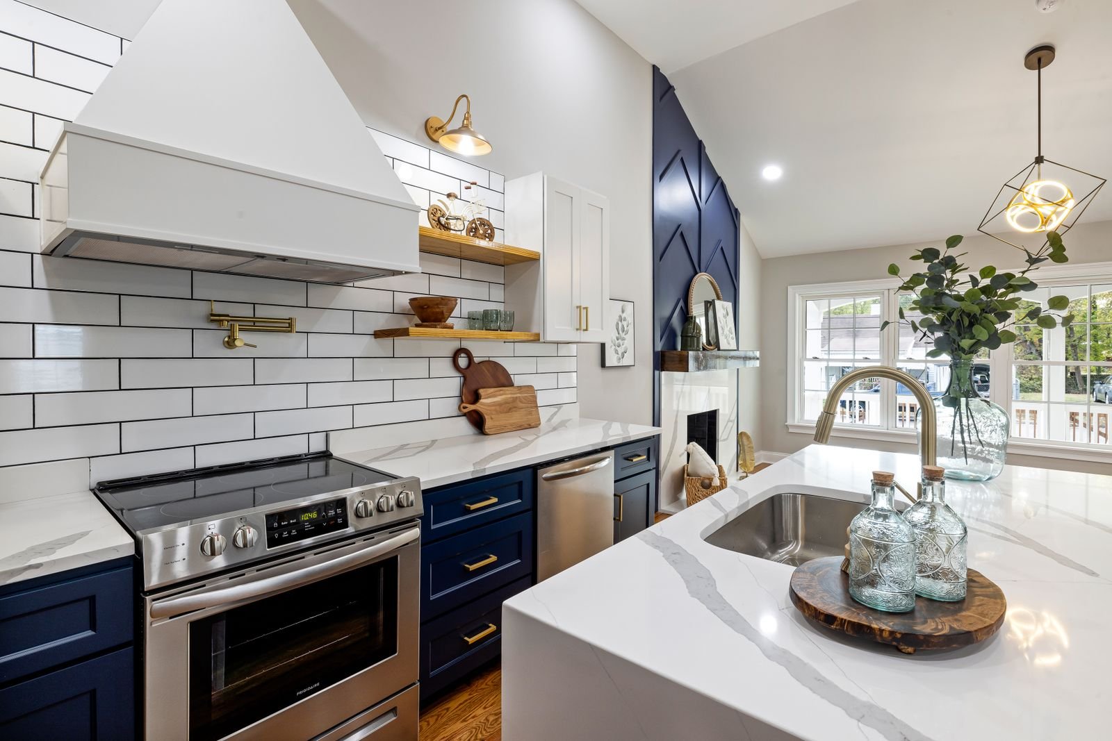 Farmhouse-style kitchen with blue cabinetry, subway tile, and open wood shelving