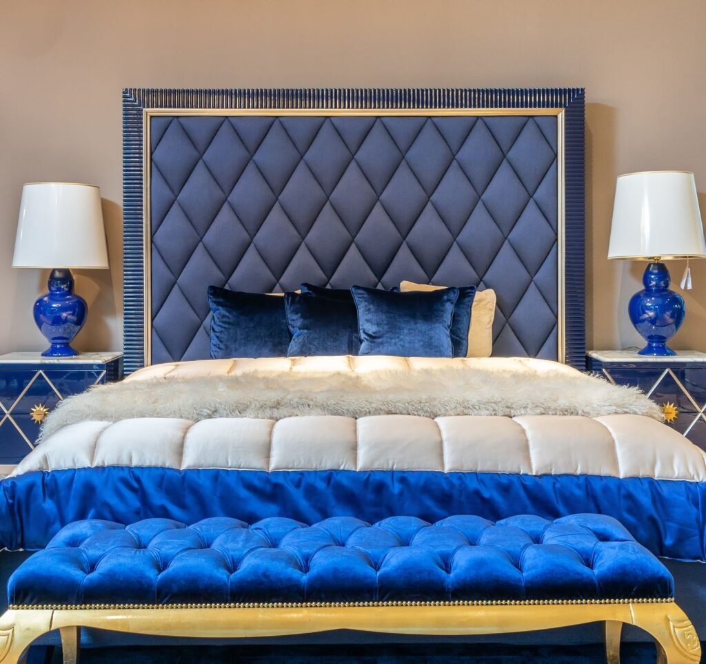 Elegant navy blue bedroom with a tufted headboard and cozy bedding