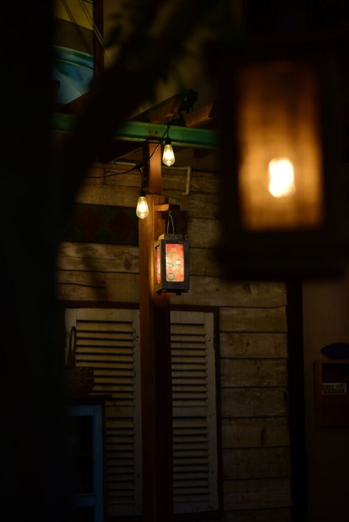 Cozy backyard patio in the evening with warm rustic lanterns and lighting