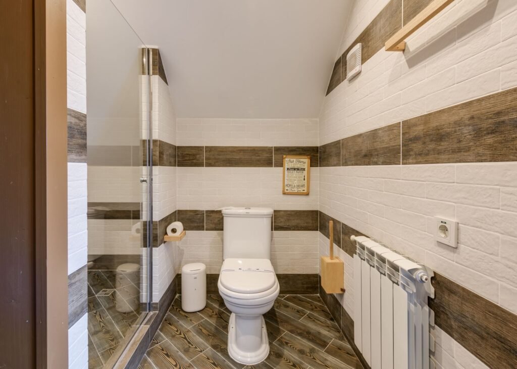 Bright minimalist small bathroom with white tiles and modern fixtures