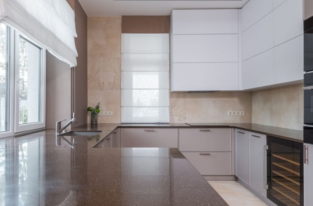 Bright minimalist small kitchen with light cabinetry and clear counters